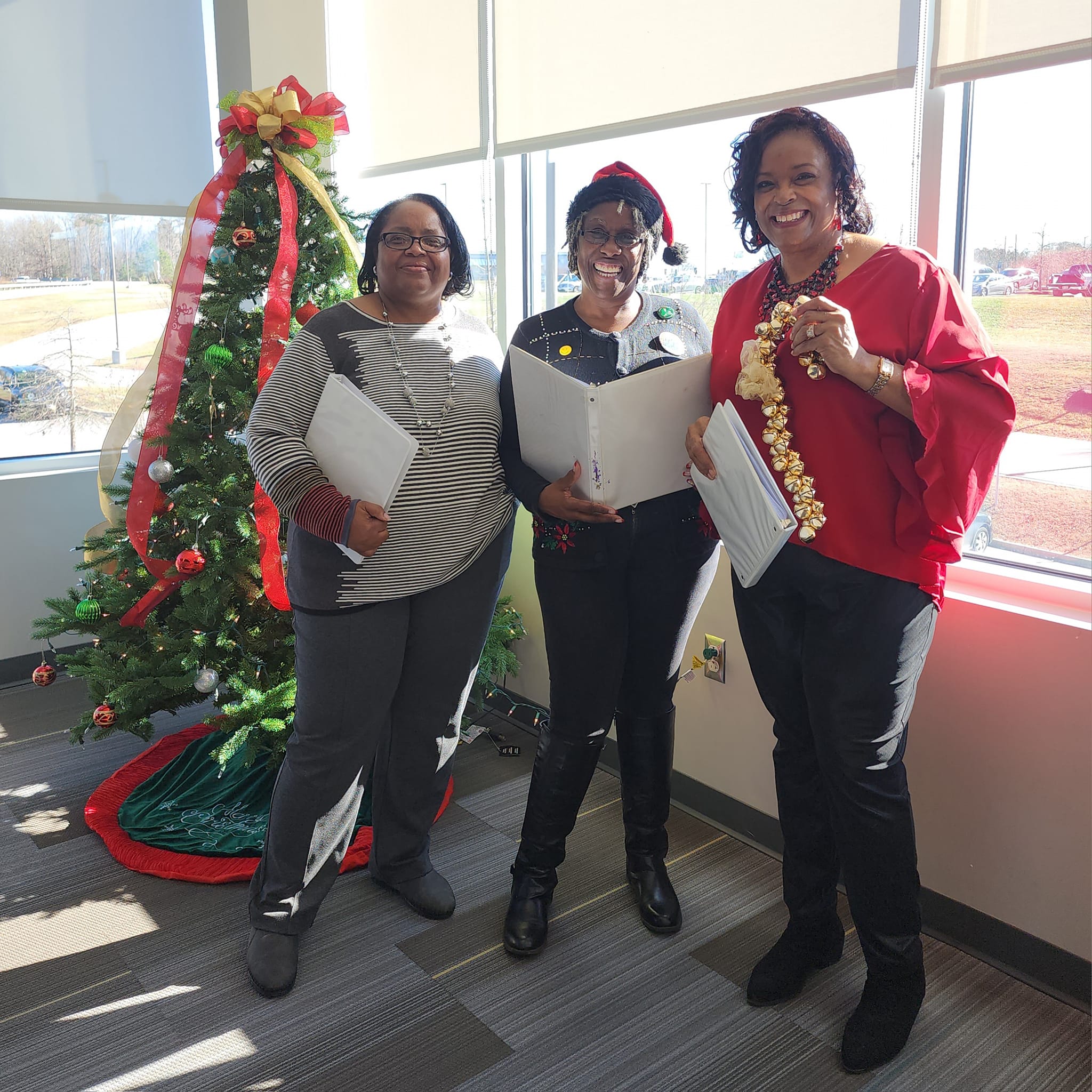 Alfredia, Jeanette, and Rachel took a moment to enjoy one of the many Christmas trees at VCU/CMH!
