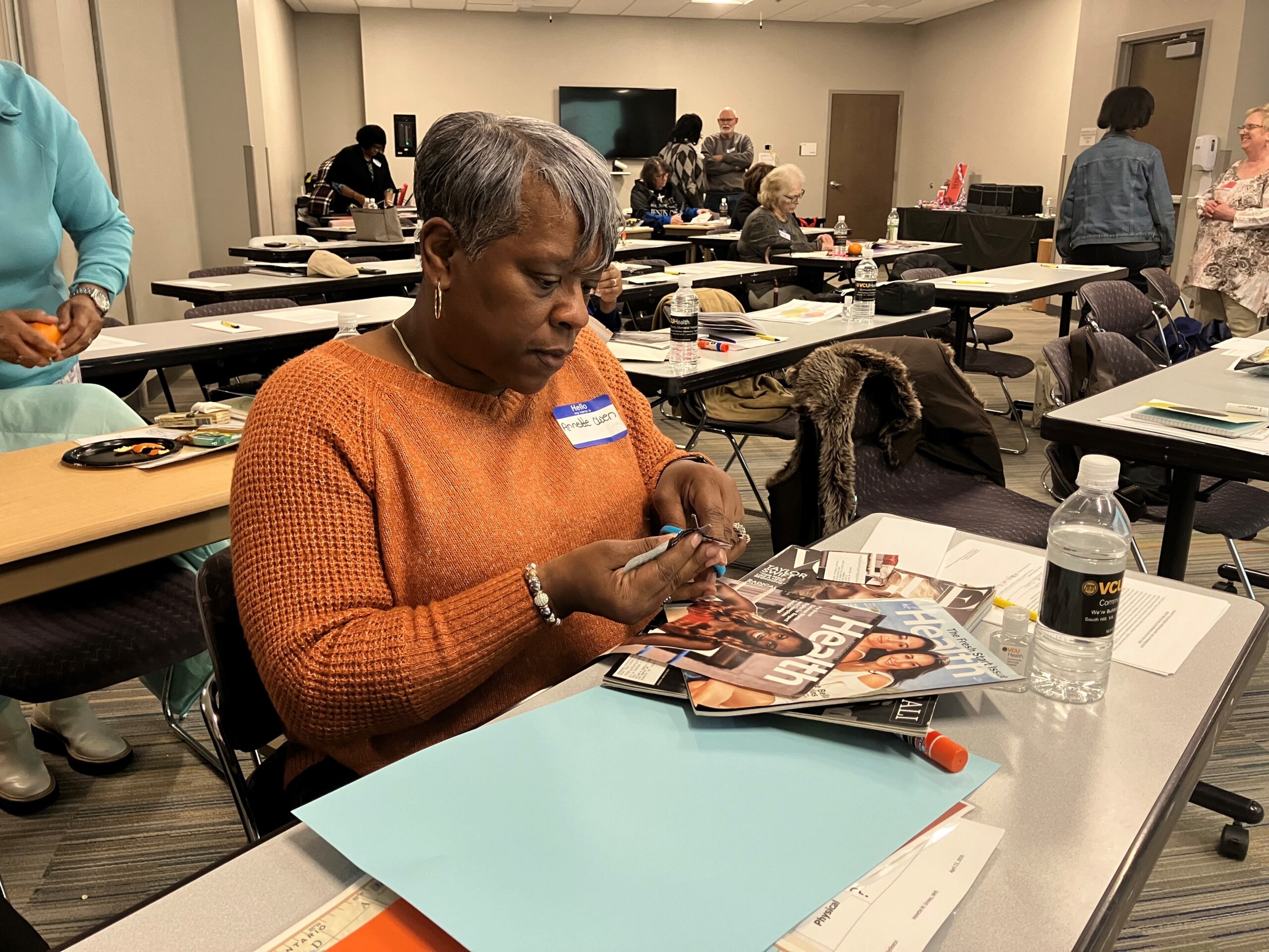 Annette Owen is working on her vision board at "Visioning a Healthier 2024".